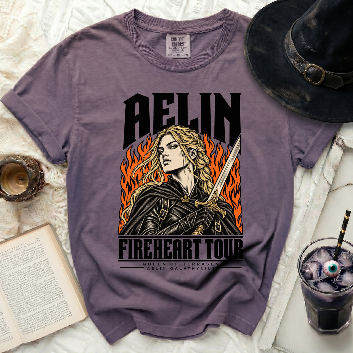Purple t-shirt with "Aelin Fireheart Tour Queen of Terrasen" design and graphic.