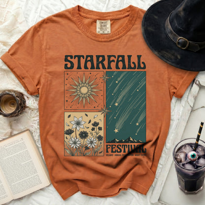 Orange t-shirt with "Starfall Festival" graphic featuring sun, flowers, and shooting stars.