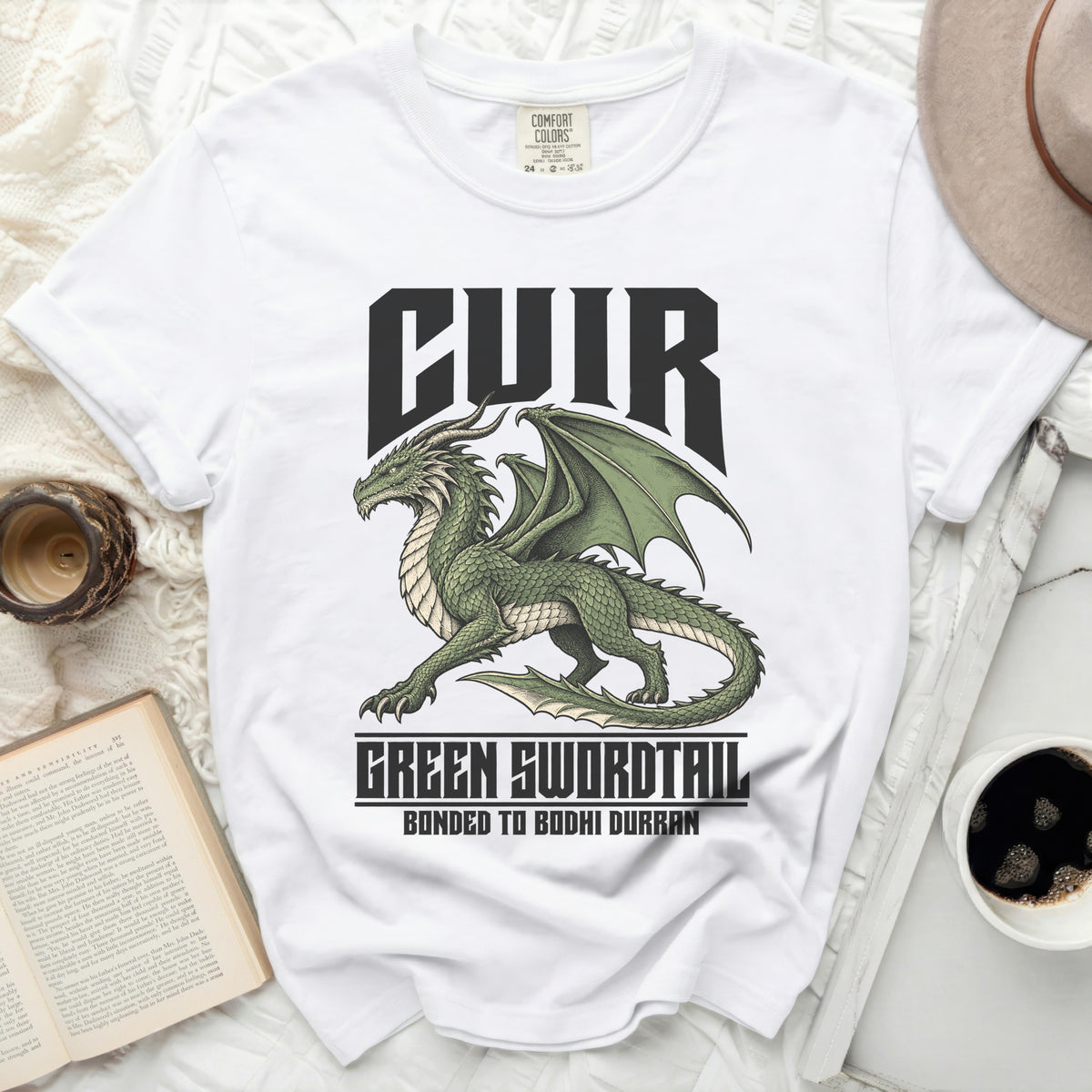 White t-shirt with green dragon graphic and text "CUIR" and "GREEN SWORDTAIL".