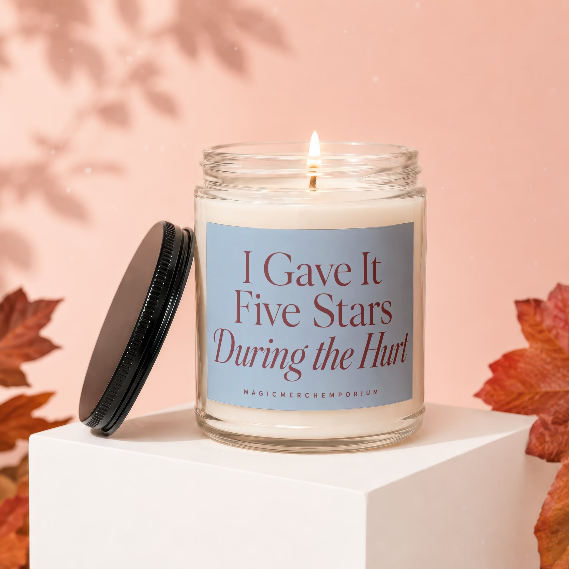 Glass candle with lid off reads "I Gave It Five Stars During the Hurt".