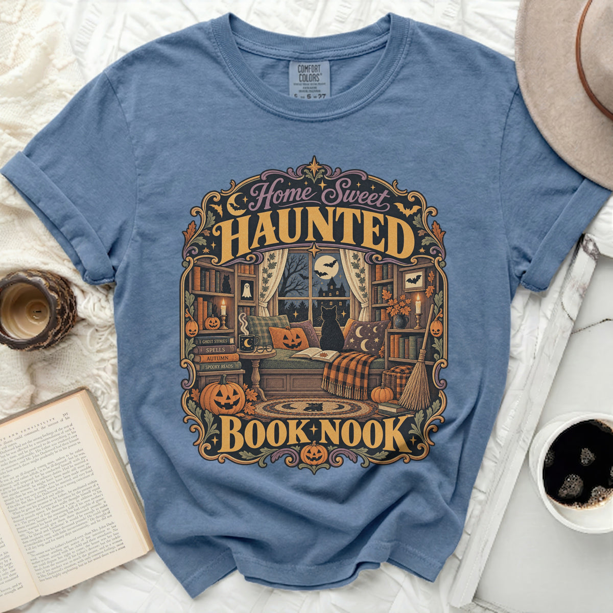 Blue t-shirt with "Home Sweet Haunted Book Nook" Halloween graphic.