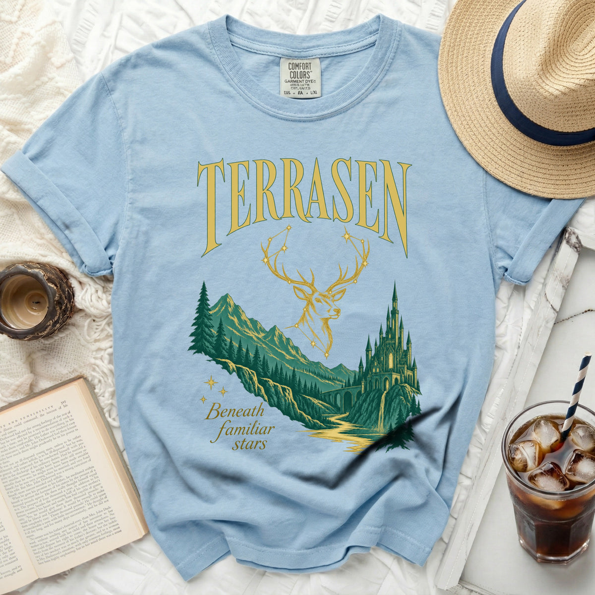 Light blue t-shirt with "TERRASEN" text, deer antlers, and a castle scene.