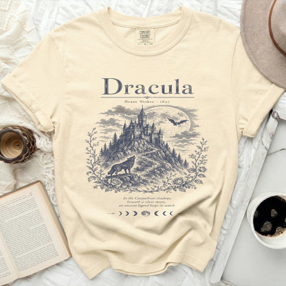 Cream t-shirt with a graphic of Bram Stoker's Dracula castle, wolf, and moon.