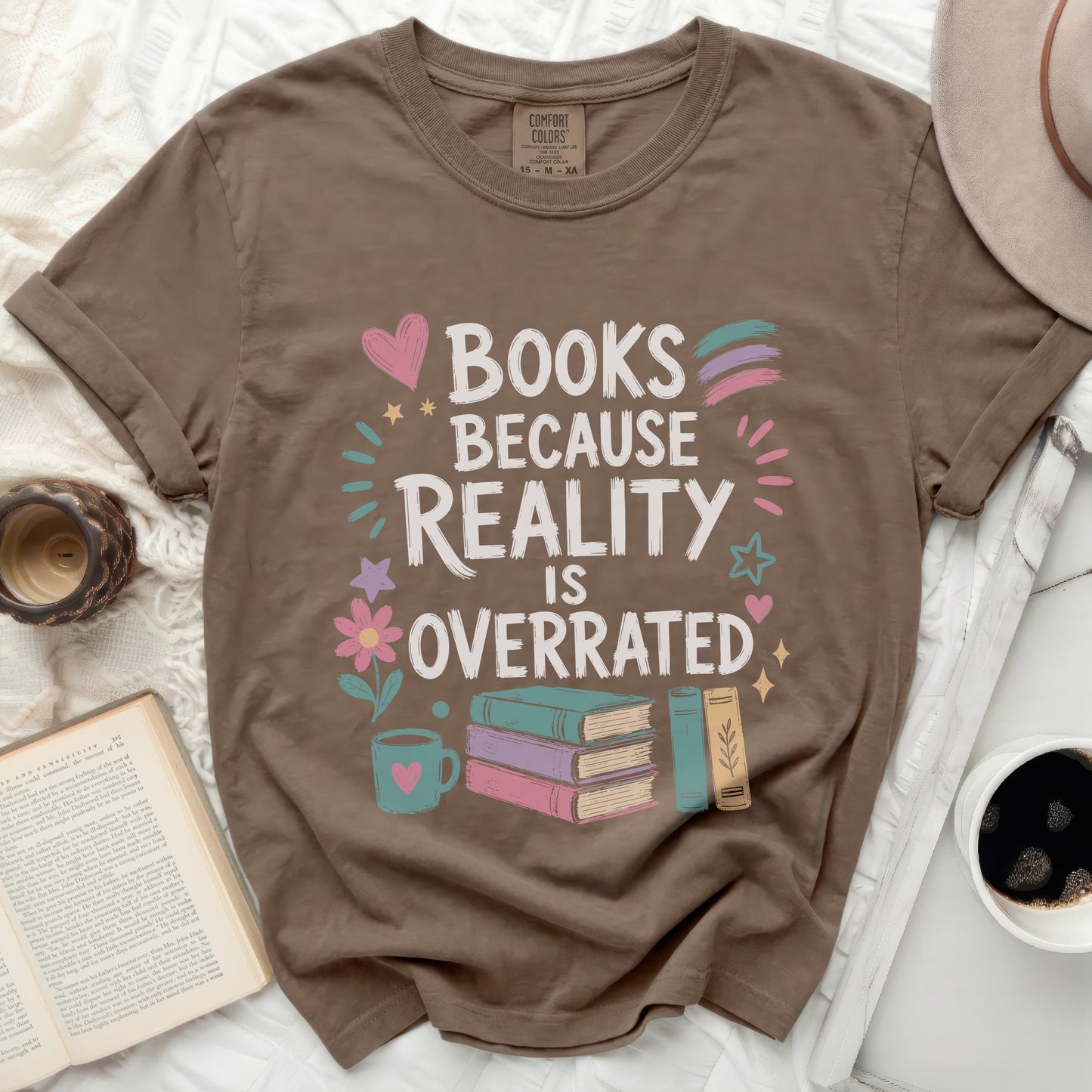 Brown t-shirt with "Books Because Reality Is Overrated" graphic and books.