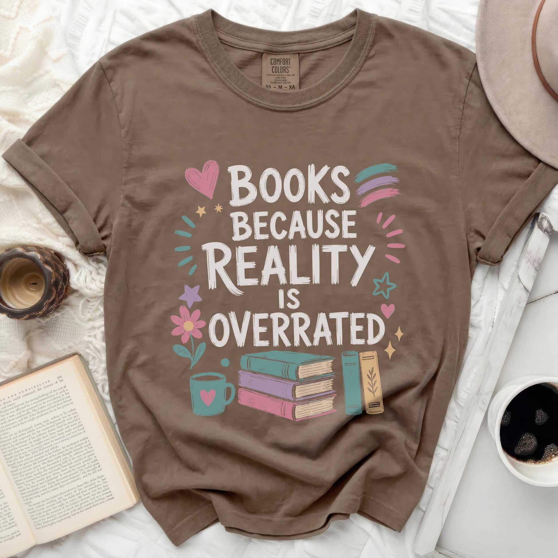 Brown t-shirt with "Books Because Reality Is Overrated" graphic and books.
