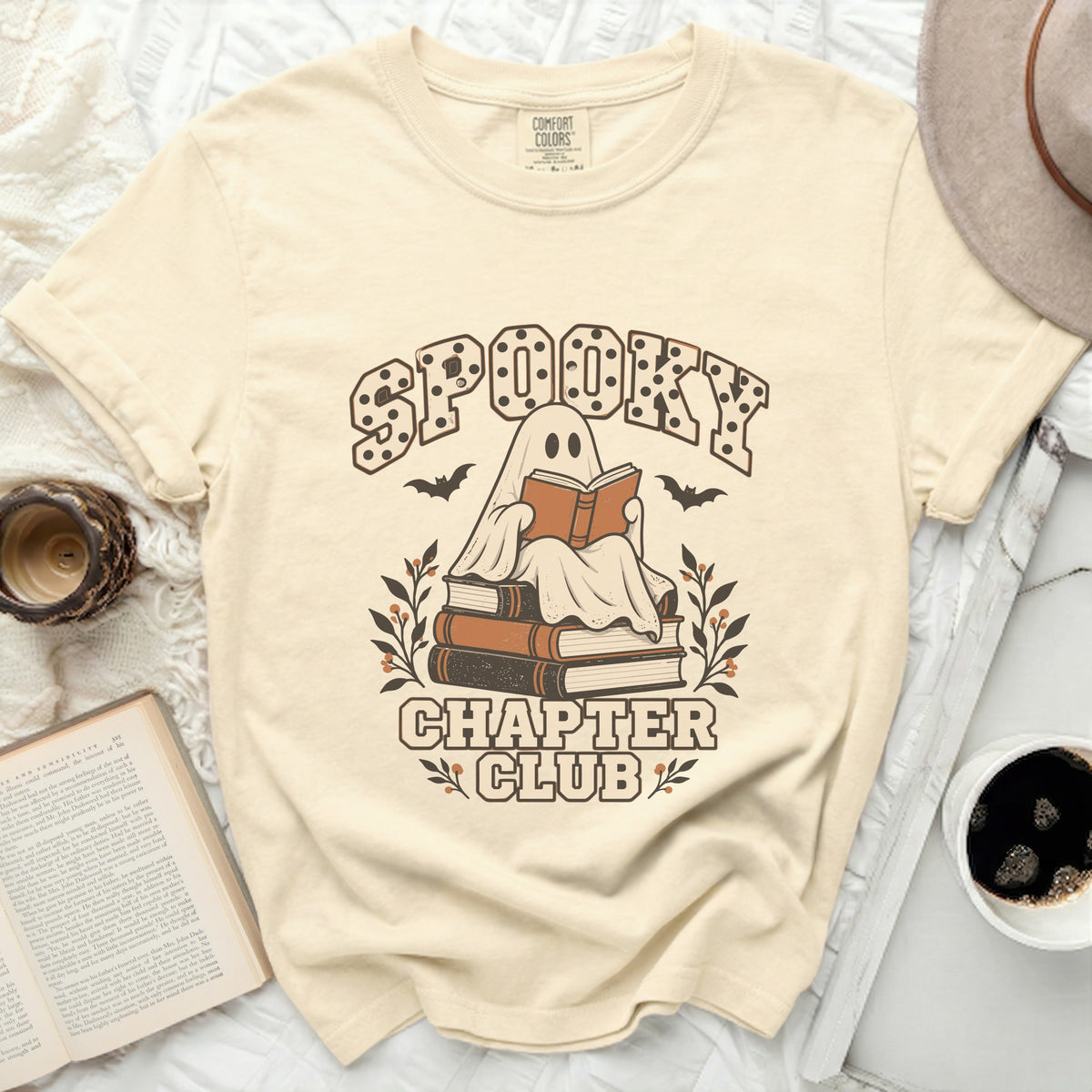 T-shirt with "Spooky Chapter Club" text, a ghost reading on books, and bats.