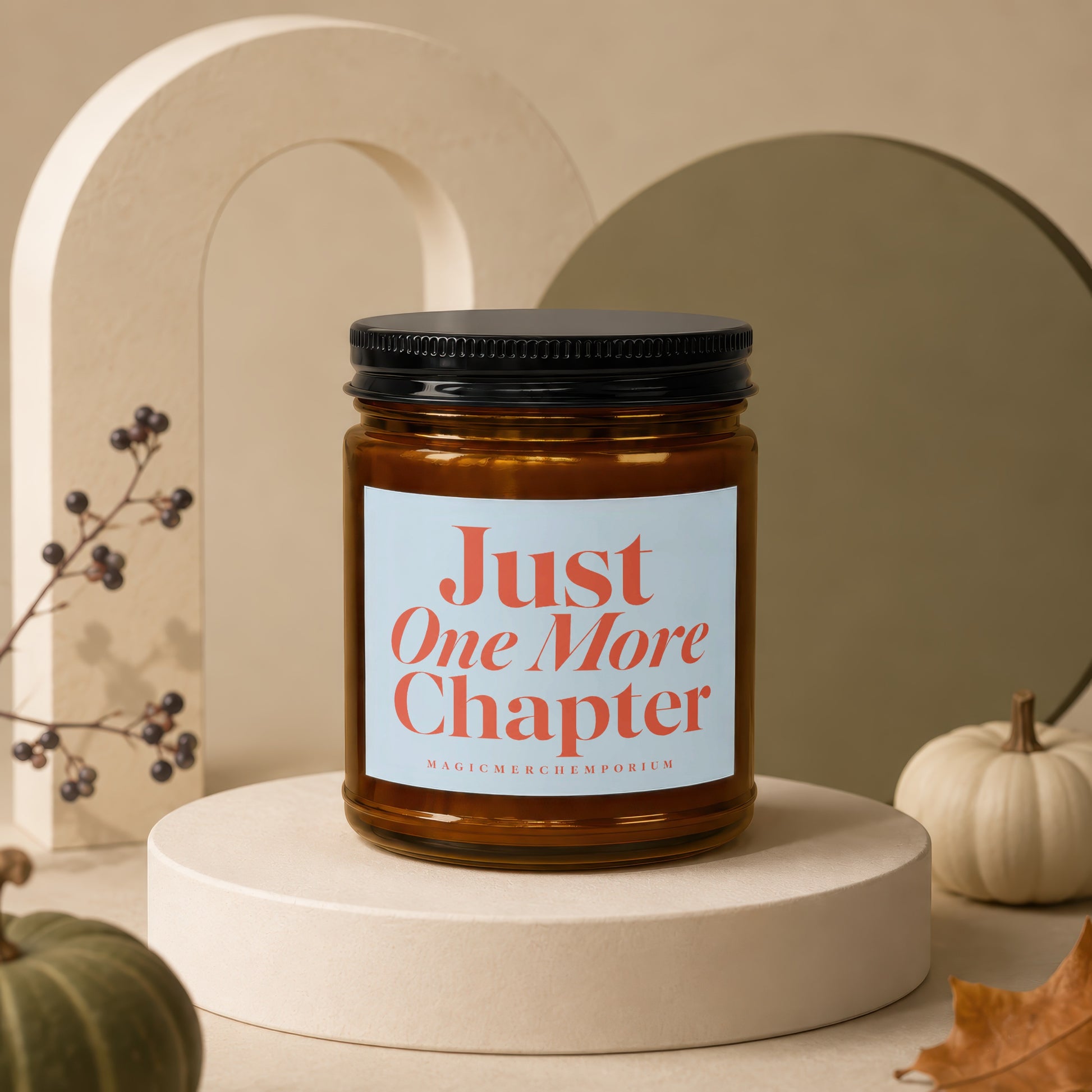 Amber jar candle with "Just One More Chapter" text and "MAGICMERCHEMPORIUM" logo.