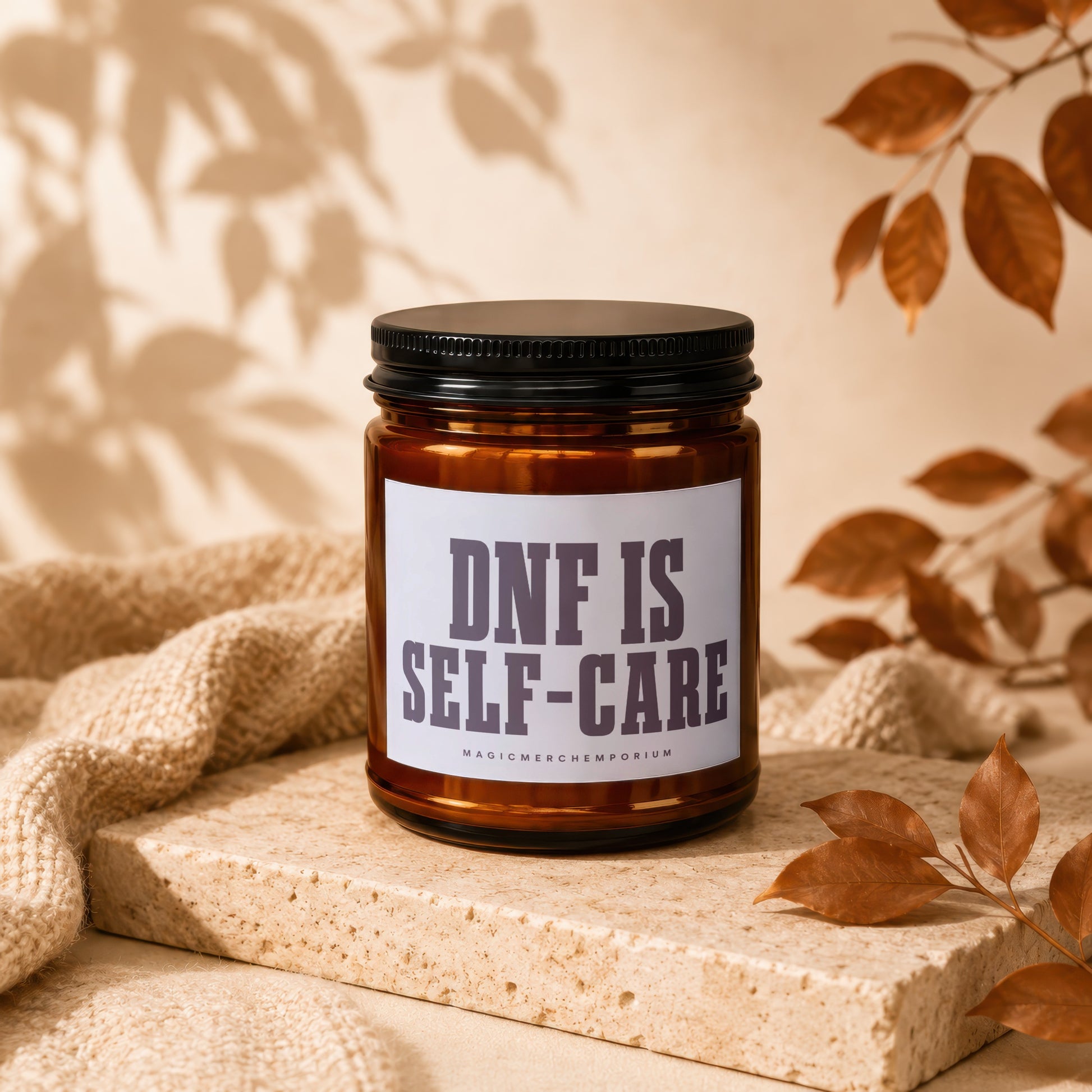 Amber jar candle with black lid stating "DNF IS SELF-CARE".