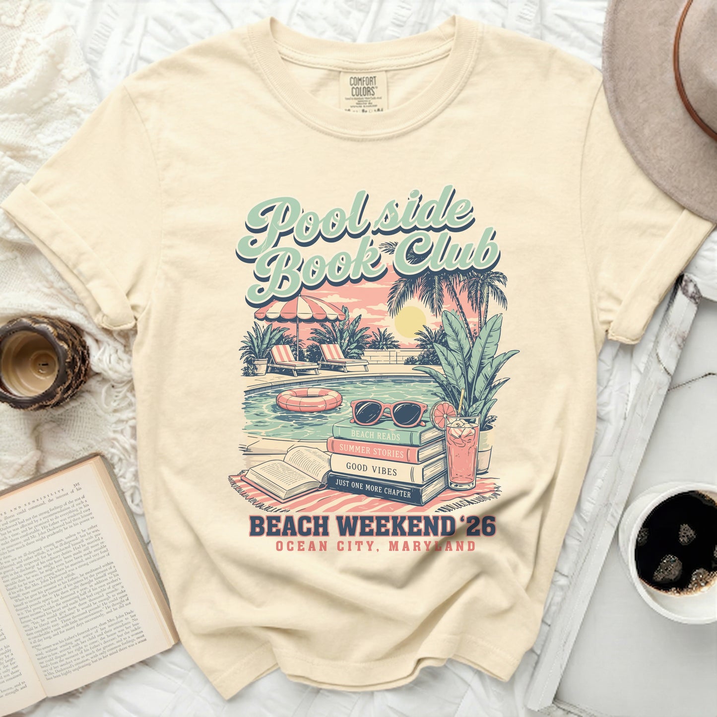 Cream t-shirt with "Poolside Book Club" graphic, beach scene, and text.