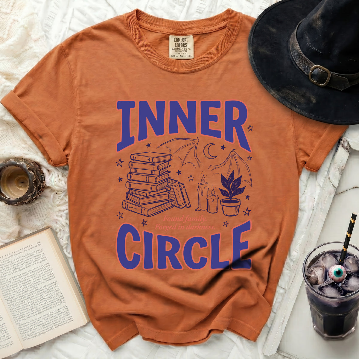 Orange t-shirt with blue text "INNER CIRCLE" and spooky graphics.