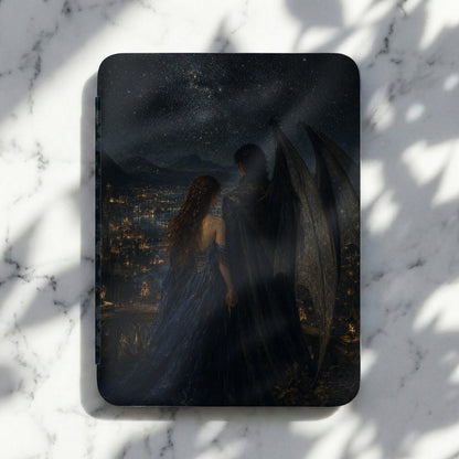 Book cover art shows couple with large wings overlooking a city at night.