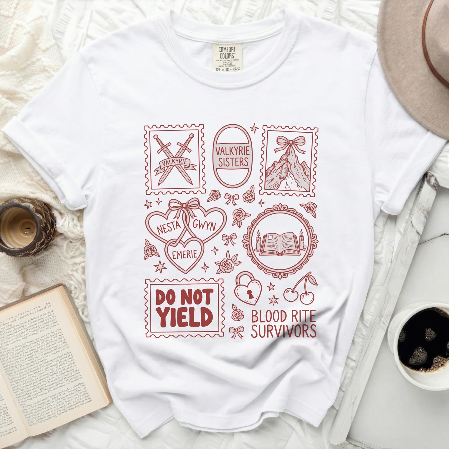 White t-shirt with red line art graphics including swords, mountains, books, and text.