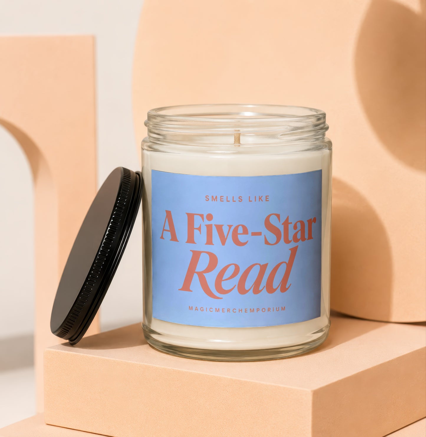 Candle with blue label reading "Smells Like A Five-Star Read MagicMerchEmporium".
