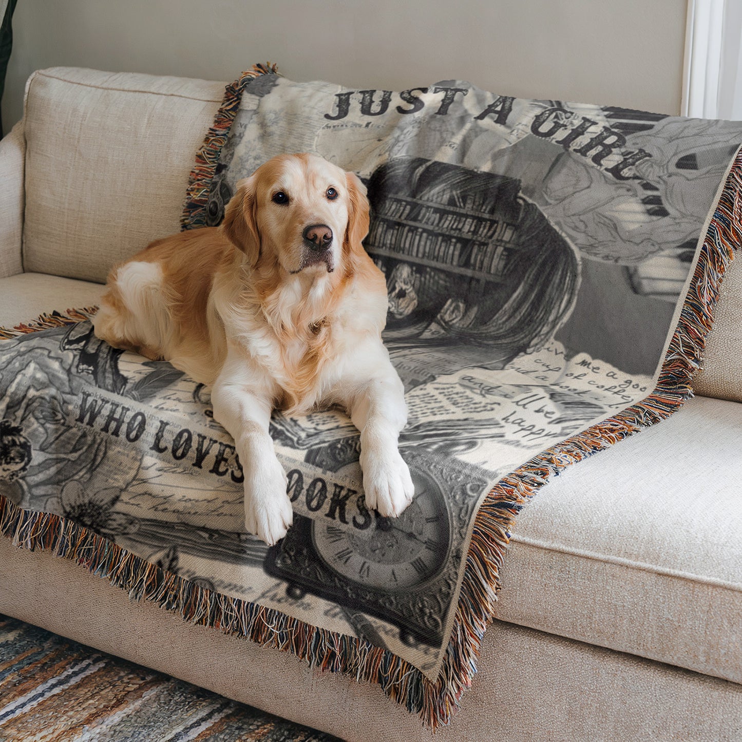 A golden retriever dog is lying on a couch with a blanket that has a book-themed design.