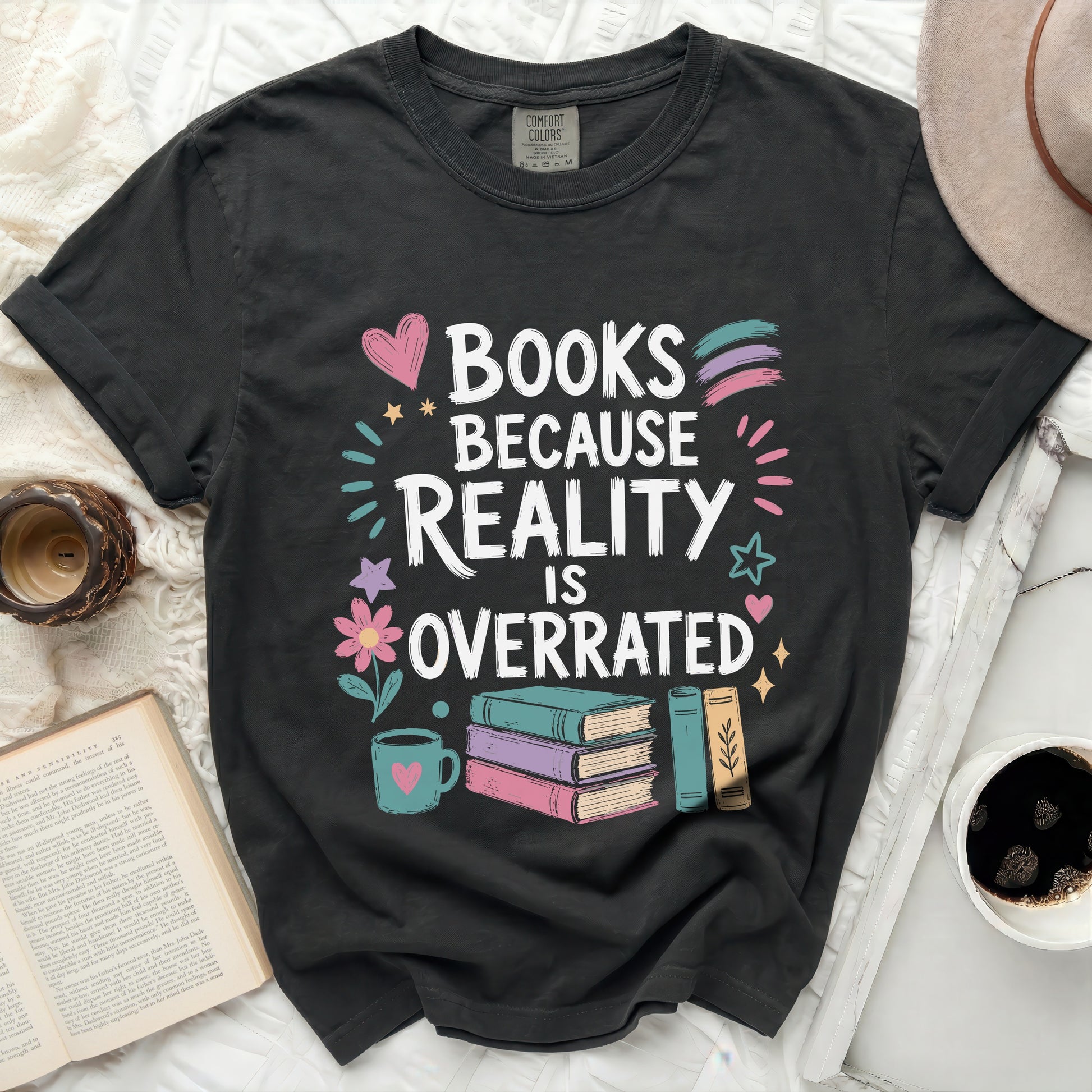 Black t-shirt with "Books Because Reality Is Overrated" text, books, and heart.