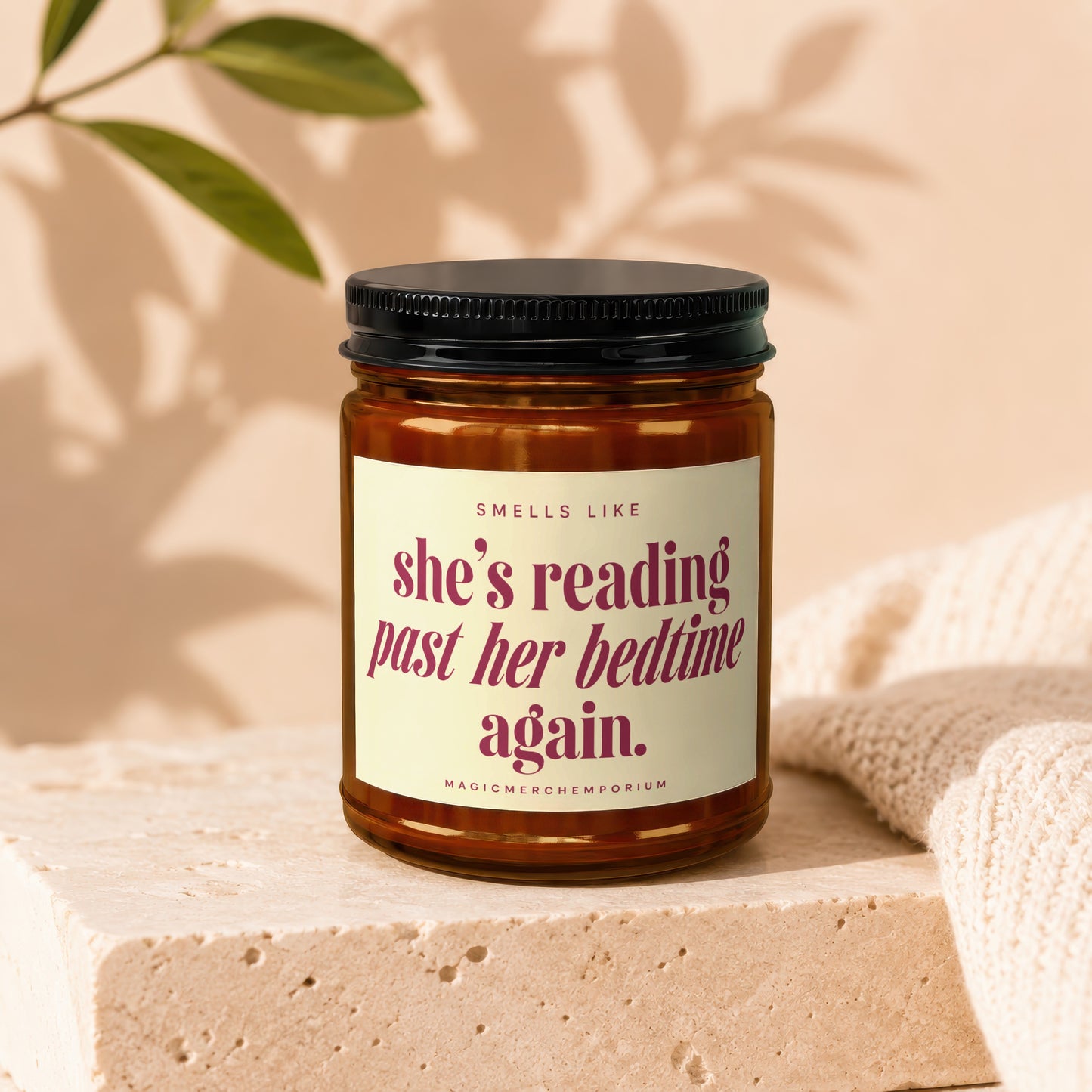 Candle with "she's reading past her bedtime again." text.