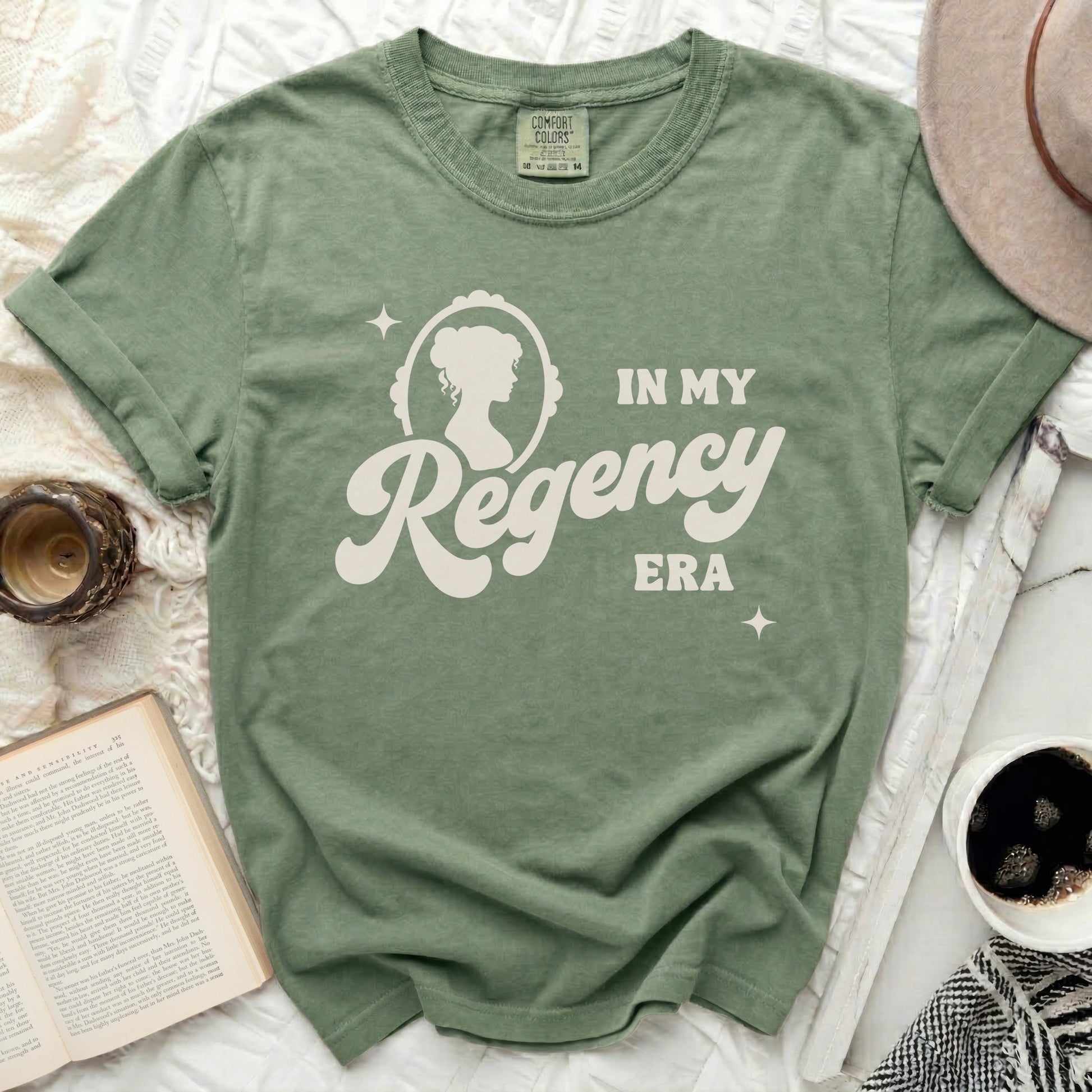 Green t-shirt with "In My Regency Era" text and cameo silhouette.