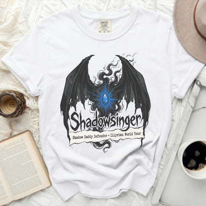 White t-shirt with black wings graphic and "Shadowsinger Shadow Daddy Defender Illyrian World Tour" text.