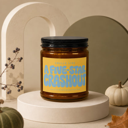 Amber candle with a yellow label reading "Smells Like A Five-Star Crashout".
