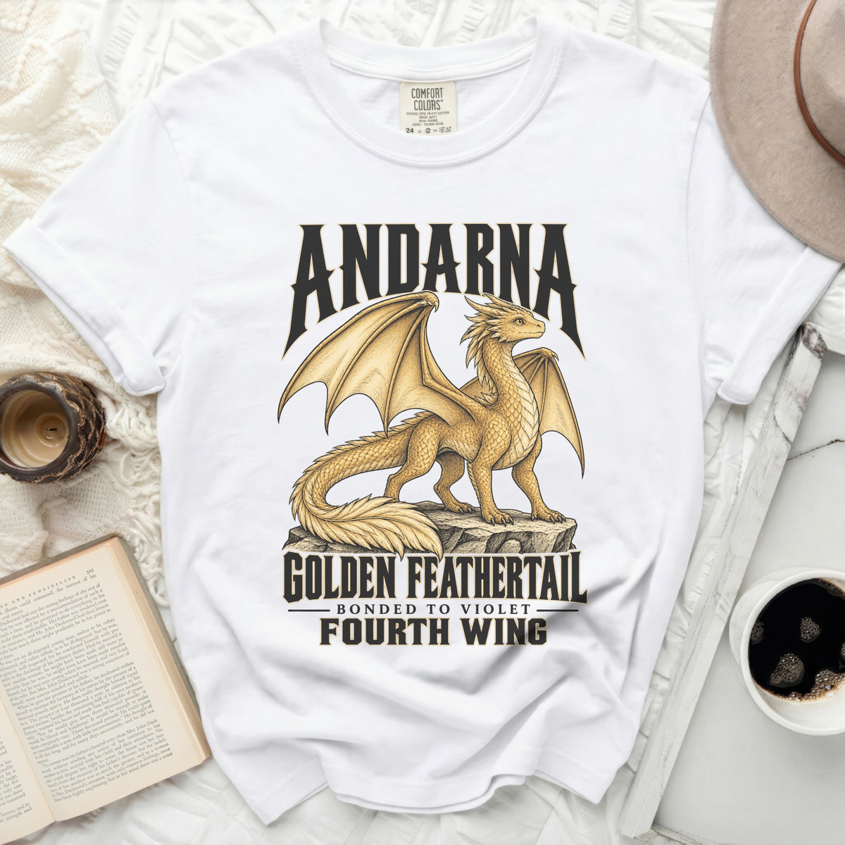White t-shirt with a golden dragon graphic, reading "Andarna Golden Feathertail" and "Fourth Wing".