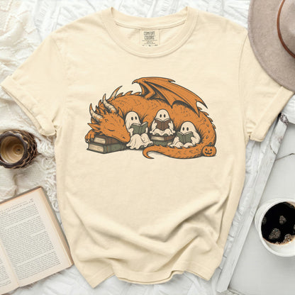 Orange dragon and ghosts reading books on stacked books with a pumpkin.