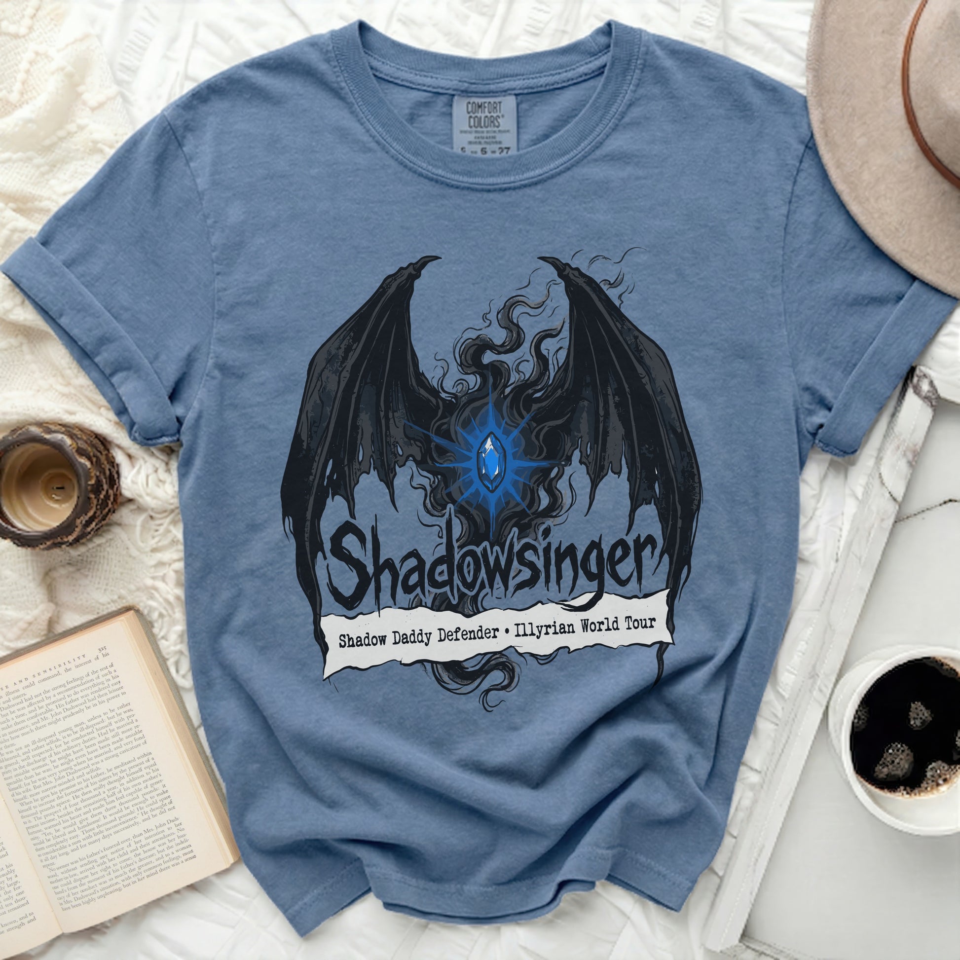 Blue t-shirt with black winged demon graphic and "Shadowsinger" text.