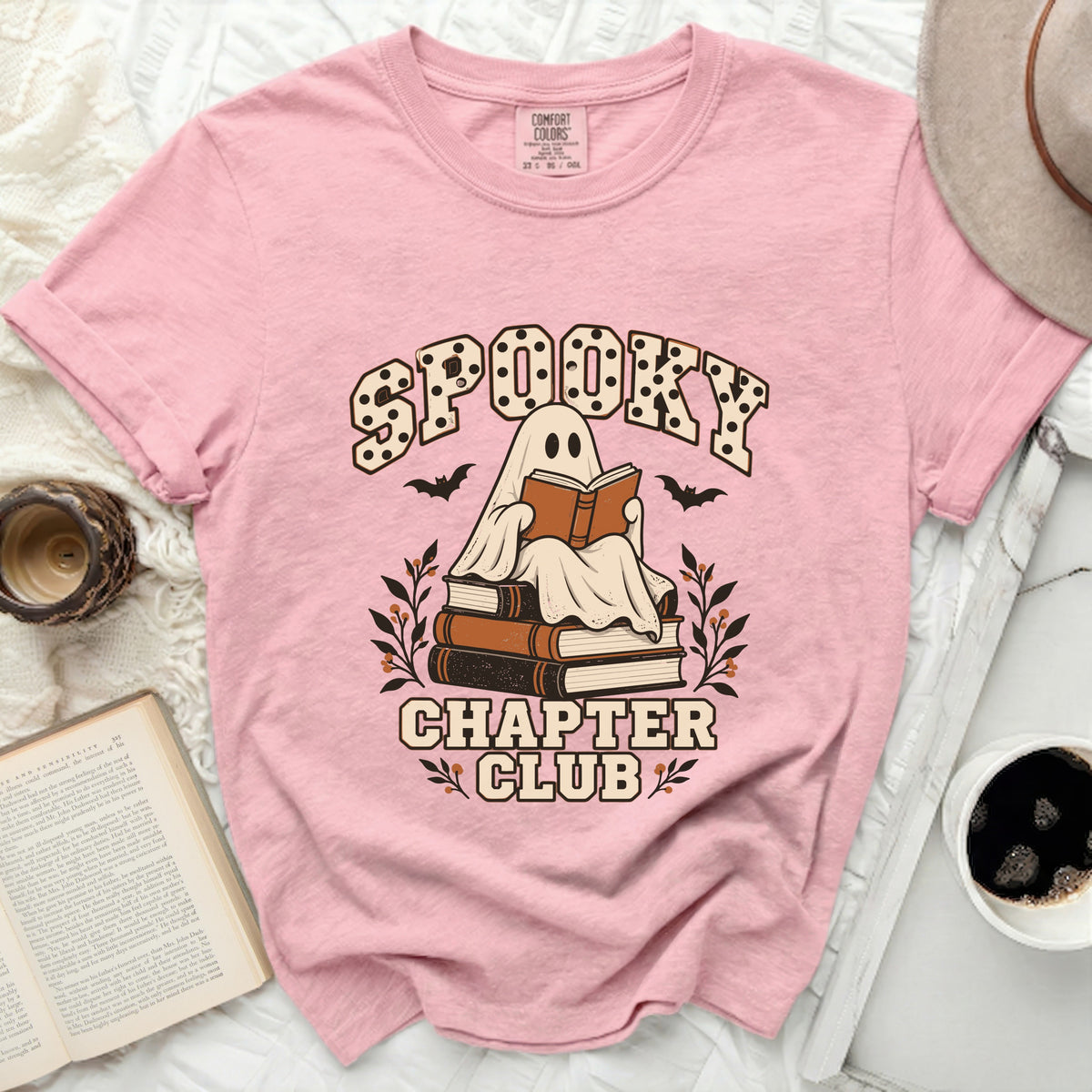 Pink t-shirt with "Spooky Chapter Club" graphic featuring a ghost reading books.