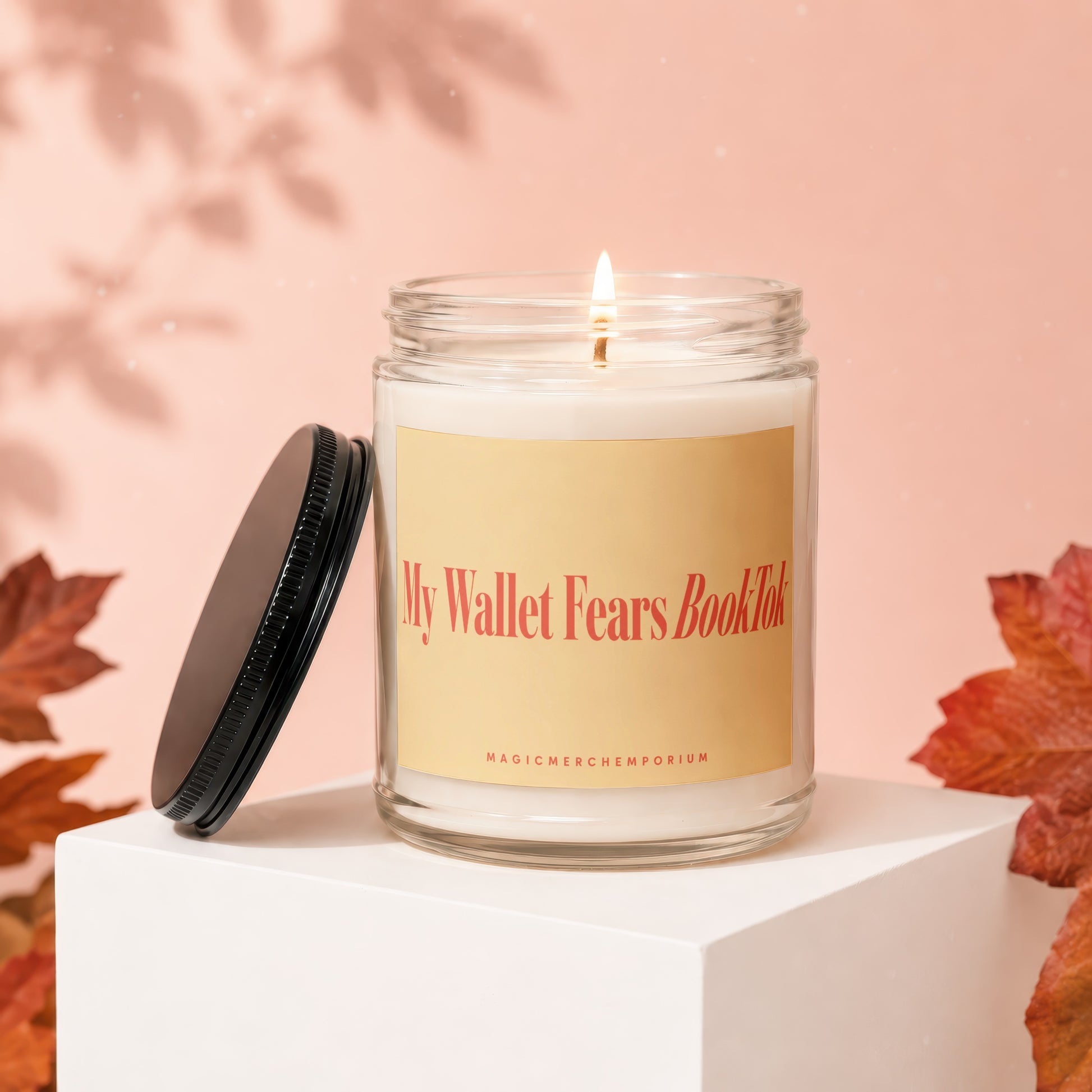 Lit candle in jar with "My Wallet Fears BookTok" label and black lid.