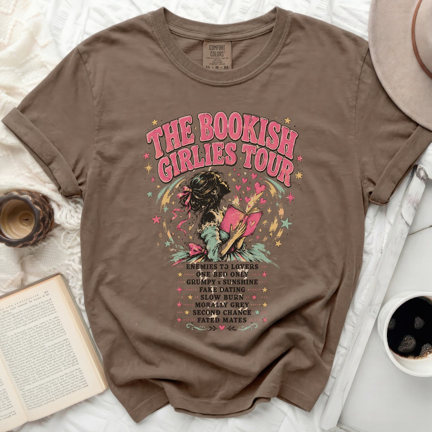 Brown t-shirt with "The Bookish Girlies Tour" text and romance novel tropes.