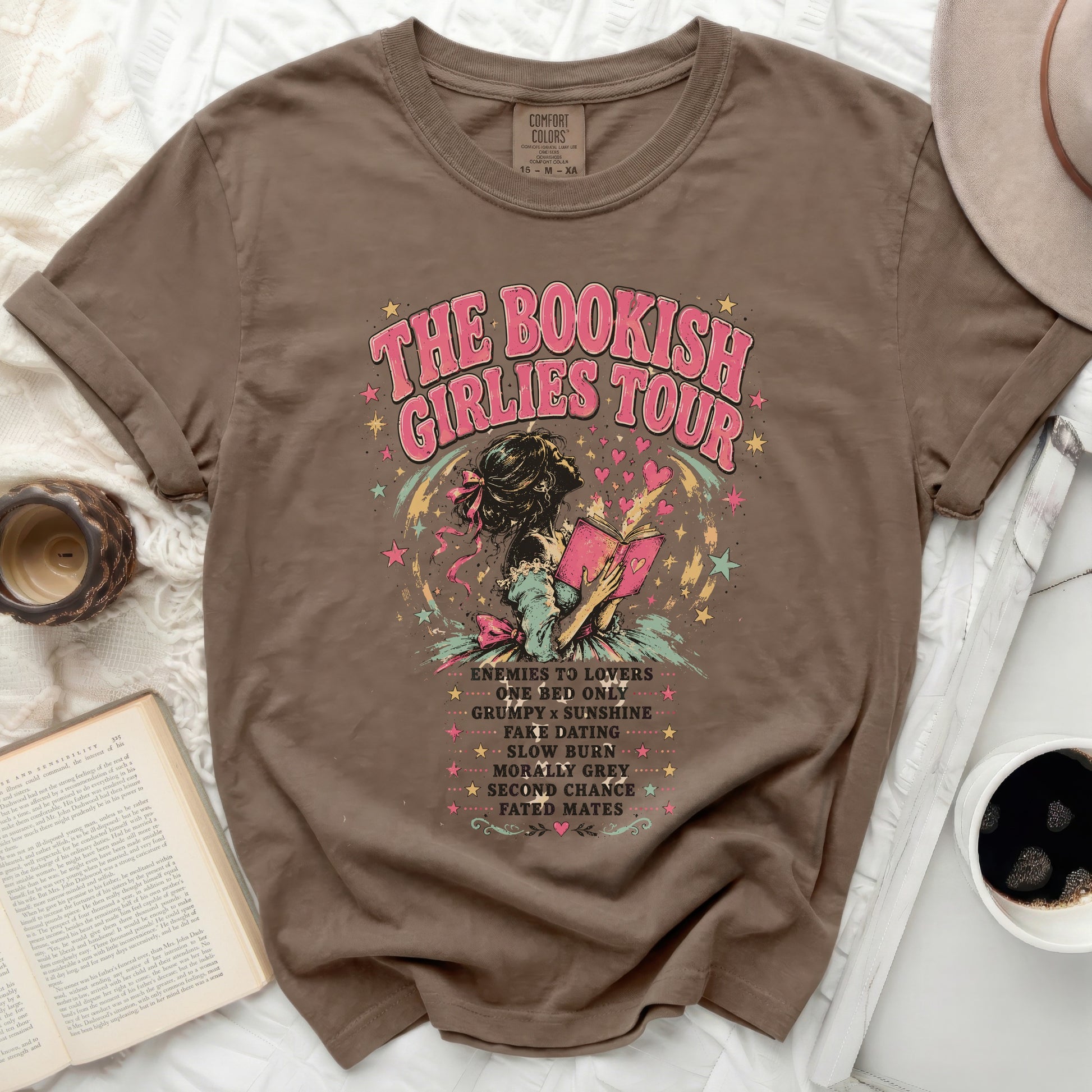 Brown t-shirt with "The Bookish Girlies Tour" text and romance novel tropes.