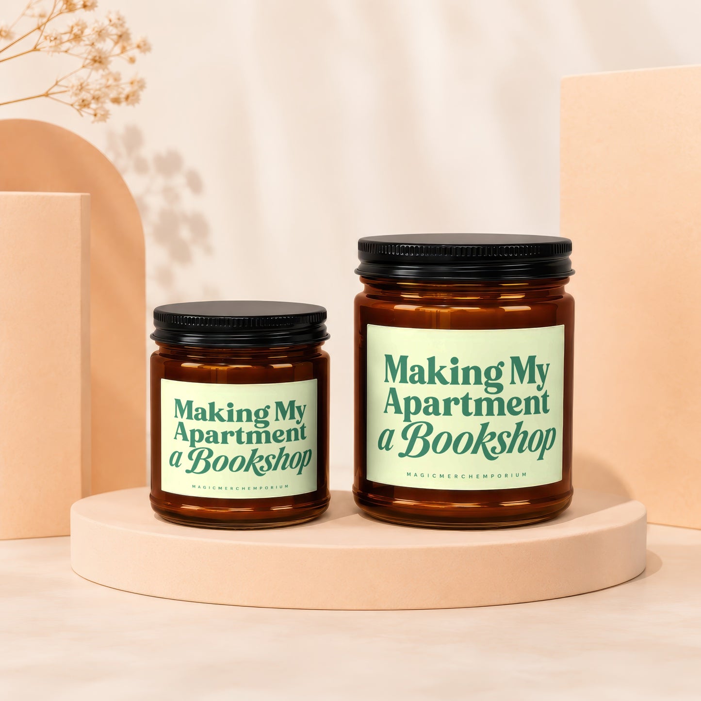 Two amber glass candles with green text: "Making My Apartment a Bookshop."