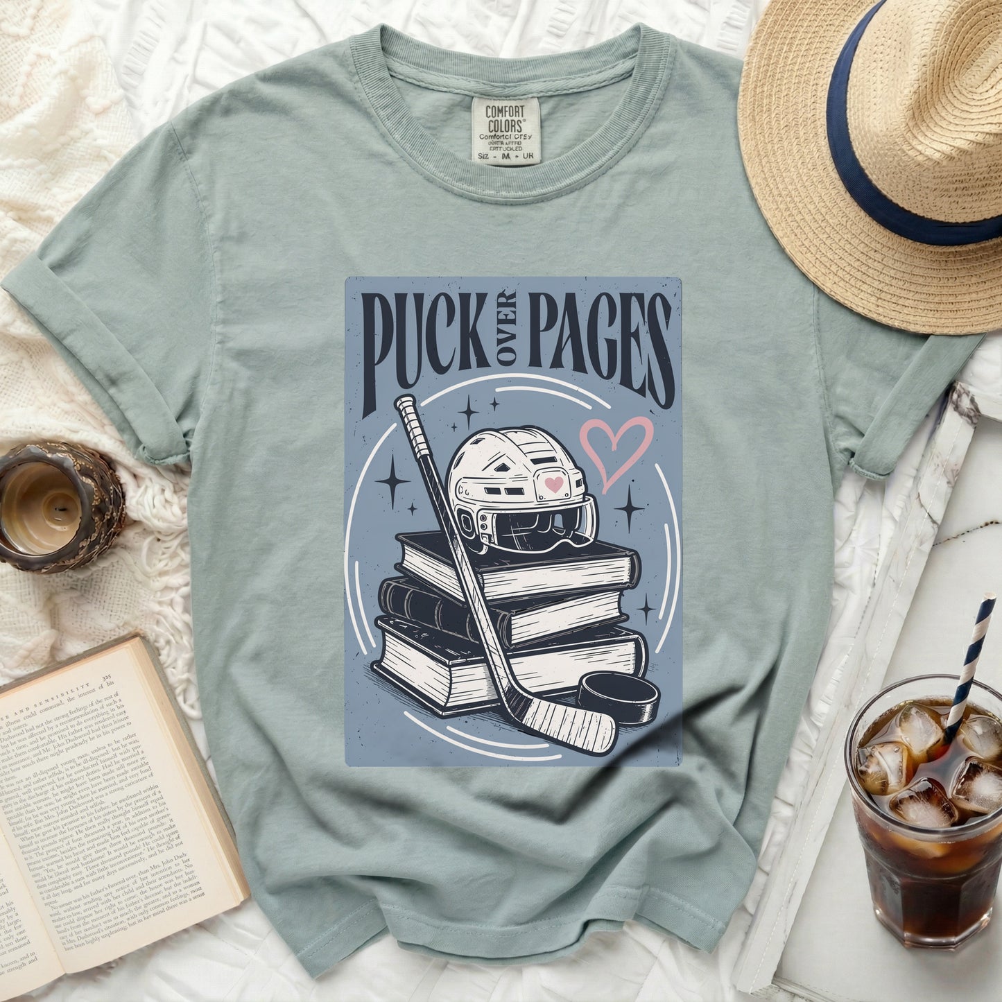 T-shirt with "Puck Pages" text, hockey stick, helmet, and pink heart.