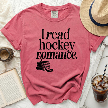 Pink t-shirt with "I read hockey romance" and book graphic.