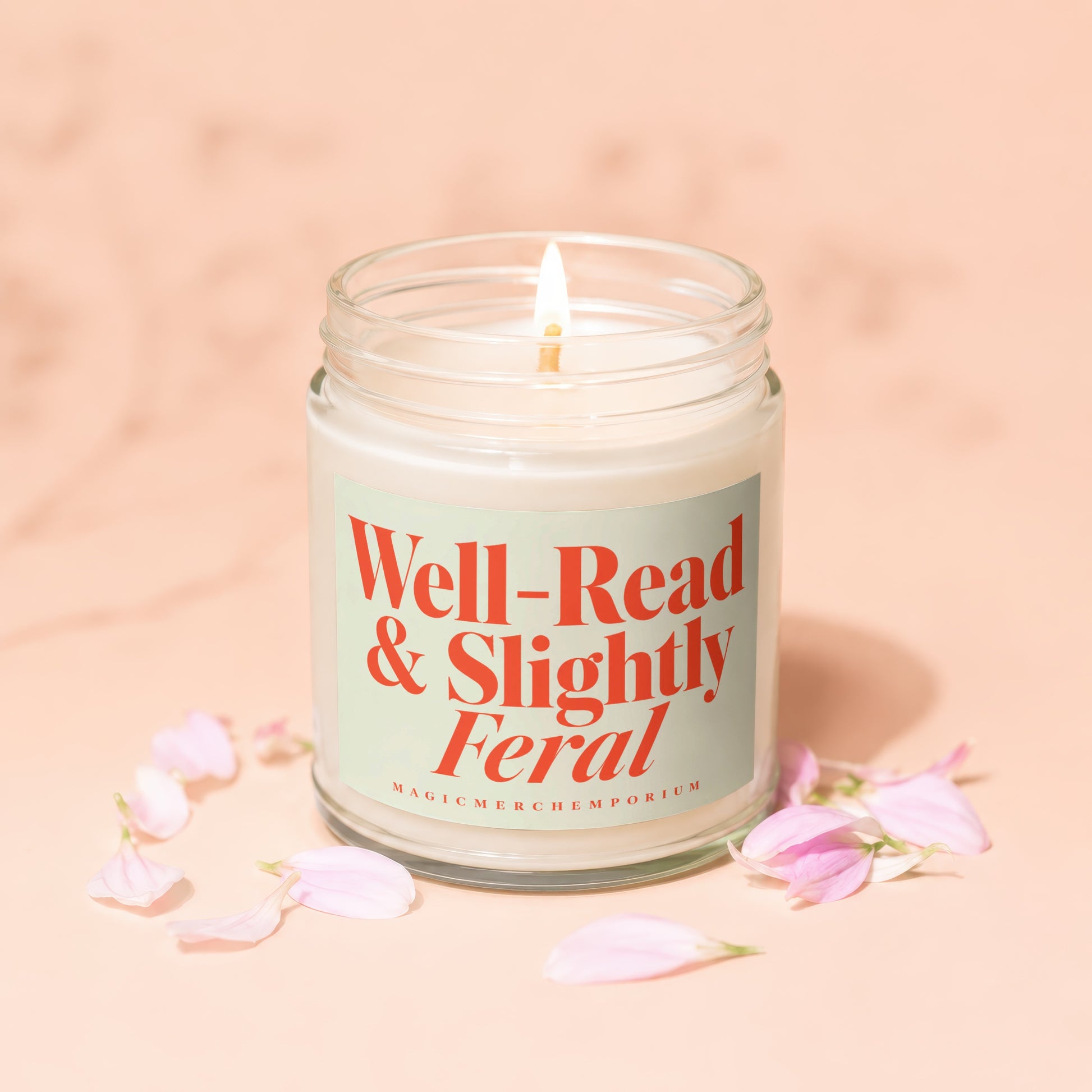 Burning candle in glass jar with label: "Well-Read & Slightly Feral"