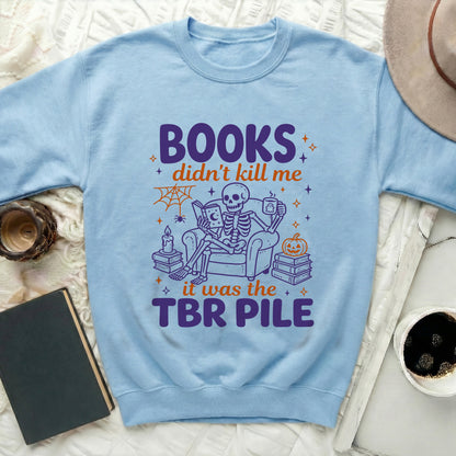 Light blue sweatshirt with a skeleton reading a book and text "BOOKS didn't kill me it was the TBR PILE".