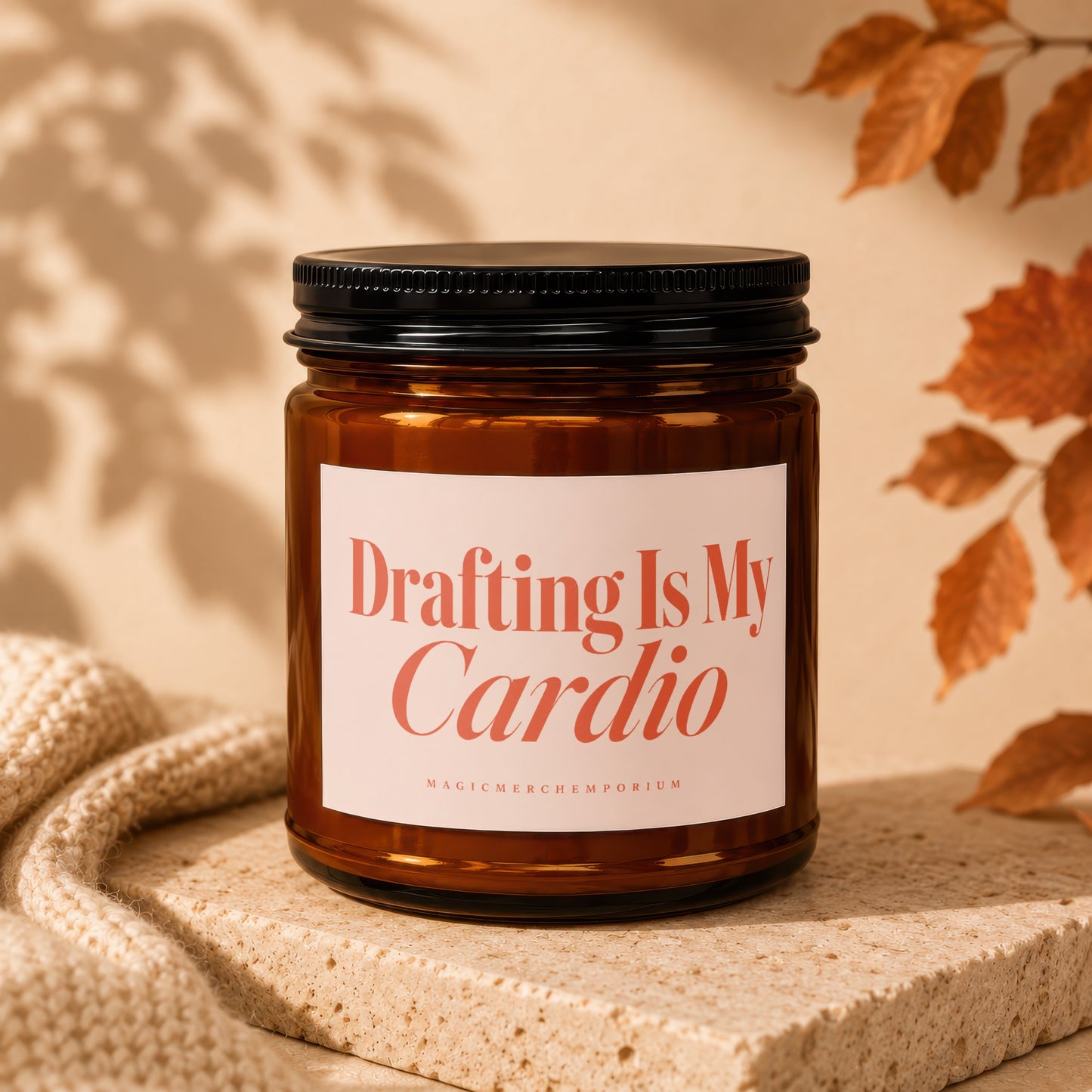 Amber glass candle with black lid reading "Drafting Is My Cardio".