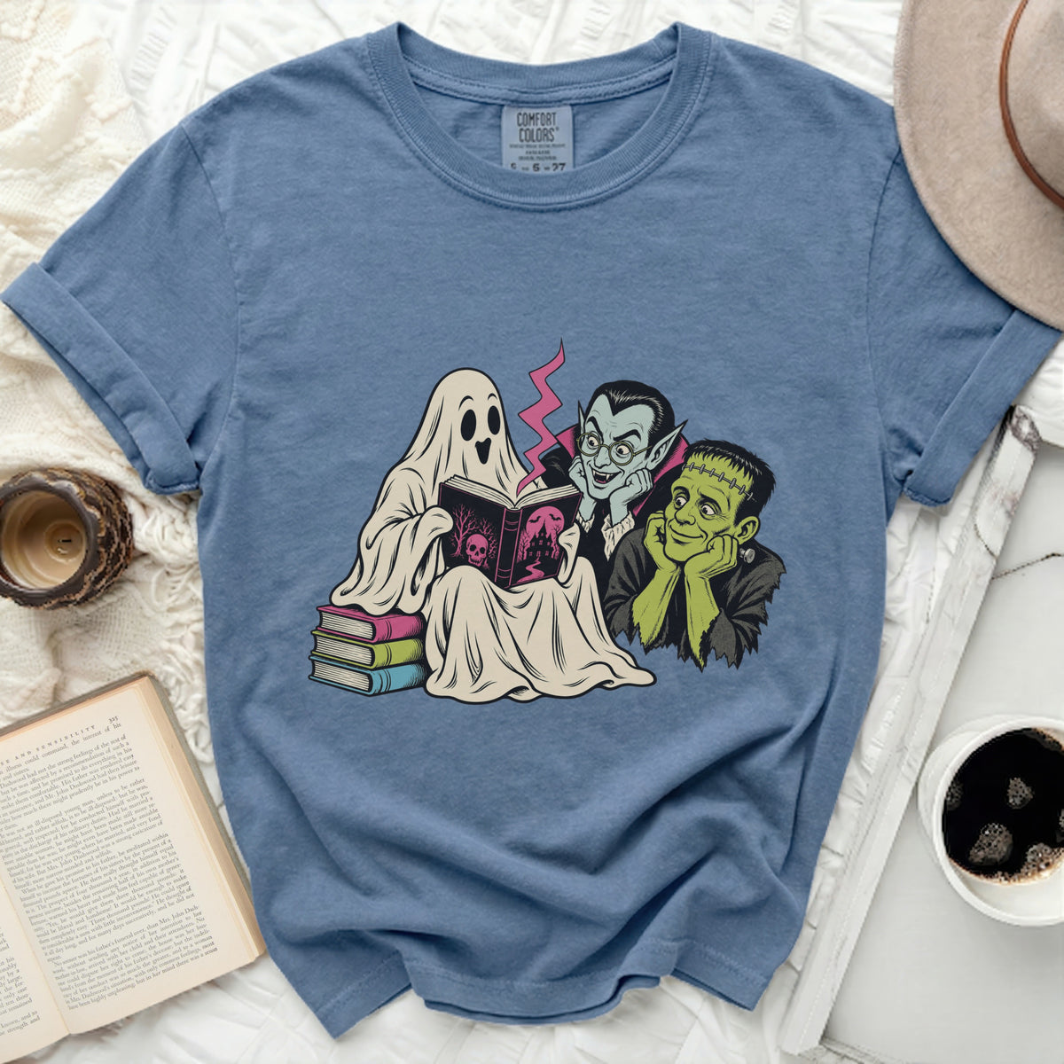 A ghost, vampire, and Frankenstein's monster read a spooky book together.