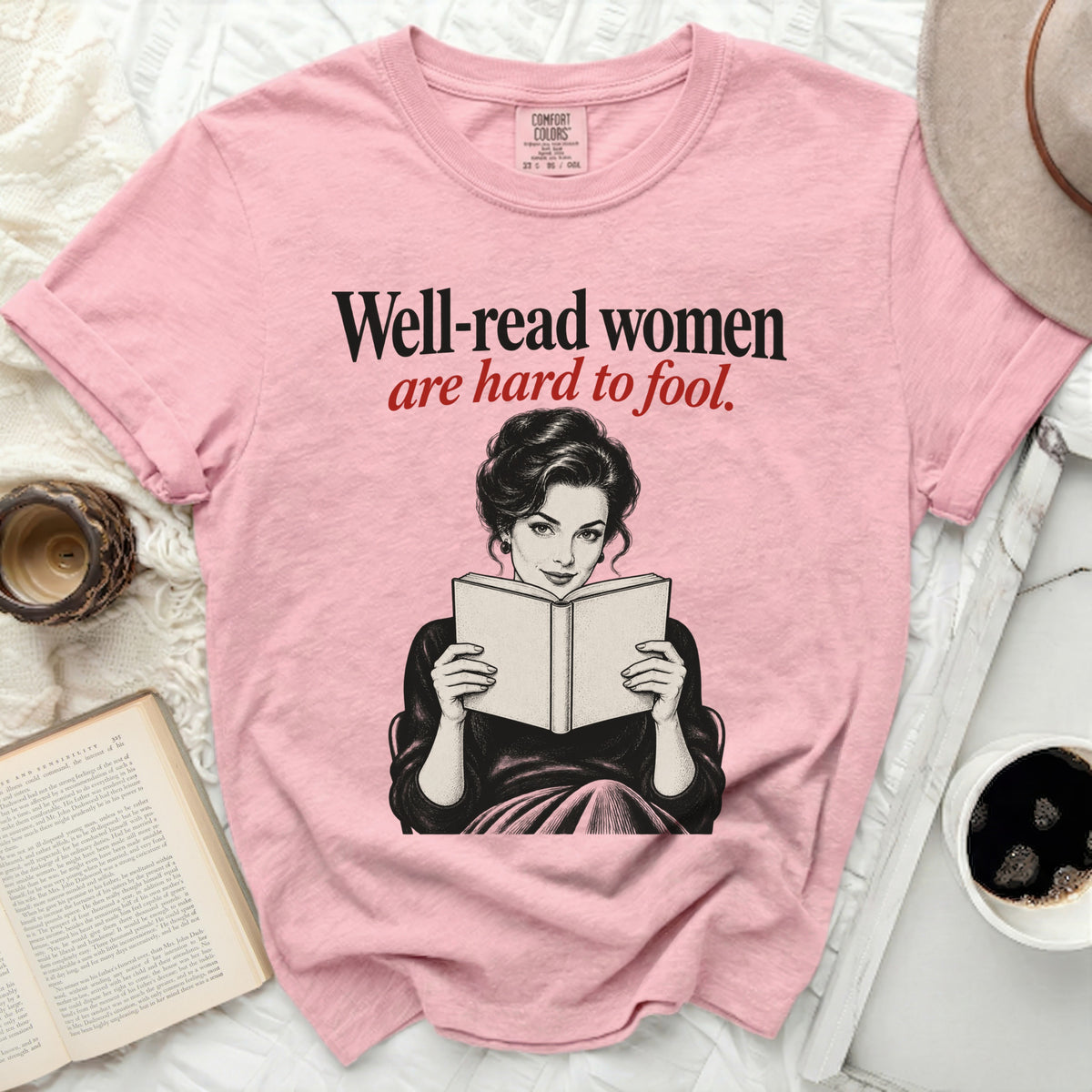 Pink t-shirt with "Well-read women are hard to fool" text and illustration.