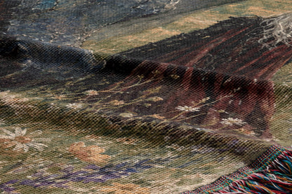 The image is a close-up of a textured fabric with a floral pattern, featuring a mix of green, brown, and white colors.