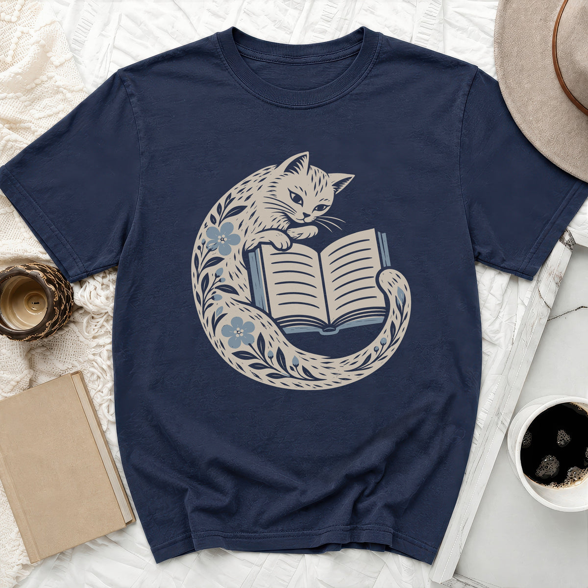 Navy t-shirt with a stylized cat reading a book design.