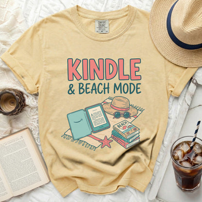 Yellow t-shirt with "KINDLE & BEACH MODE" text and book illustrations.