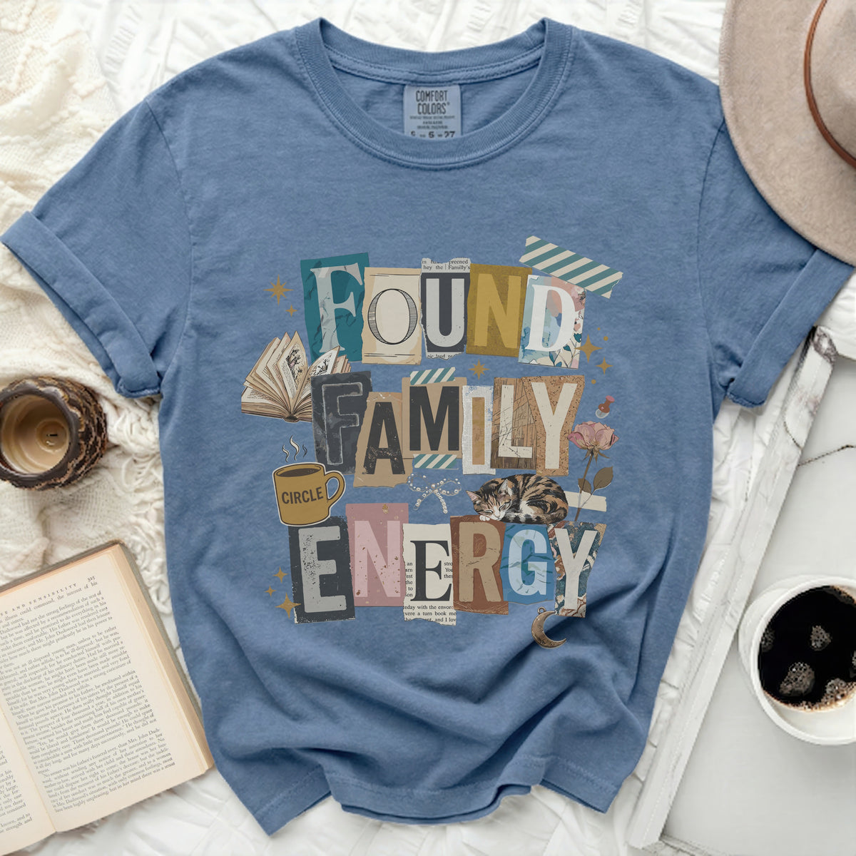 Blue t-shirt with "Found Family Energy" text and a sleeping cat graphic.