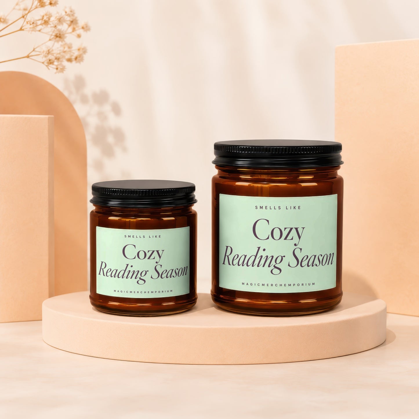 Two "Cozy Reading Season" scented candles on display pedestals.