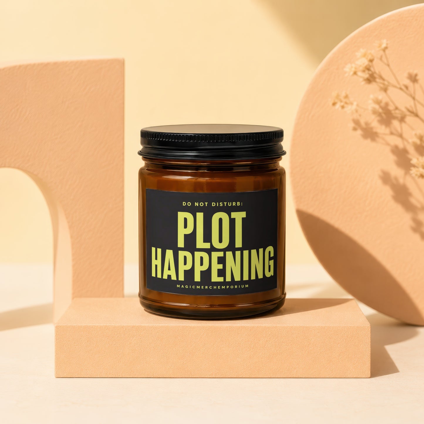 Amber glass candle with black lid reads "DO NOT DISTURB: PLOT HAPPENING"