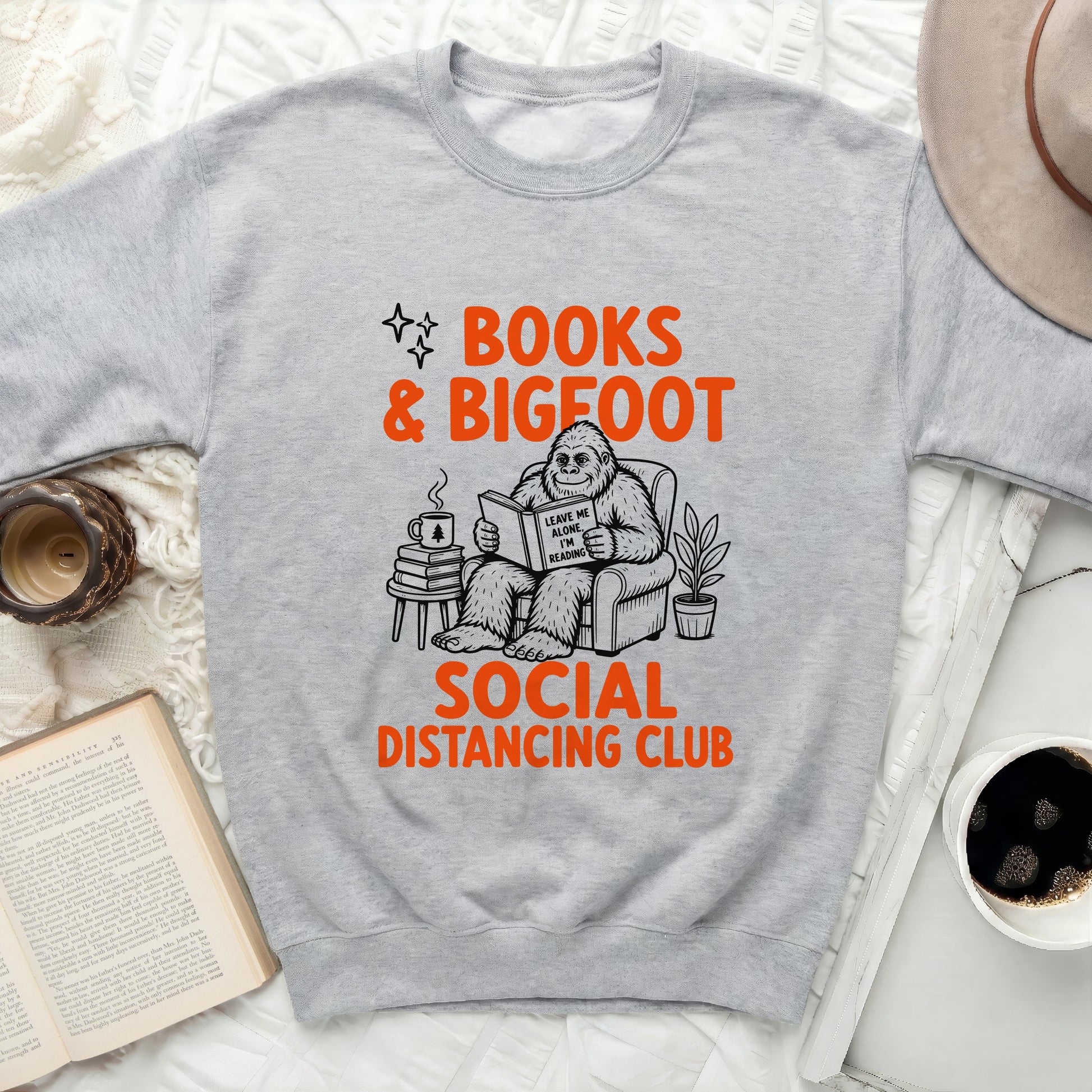 Gray sweatshirt with "Books & Bigfoot Social Distancing Club" graphic.