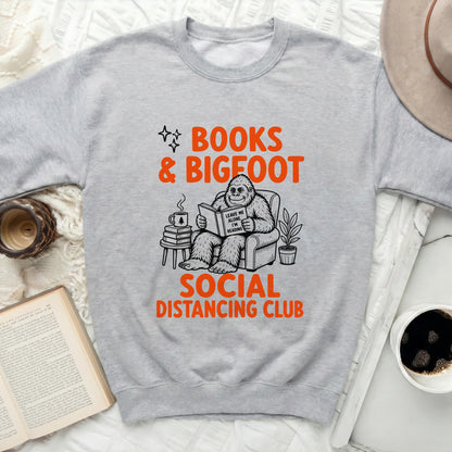Gray sweatshirt with "Books & Bigfoot Social Distancing Club" graphic.
