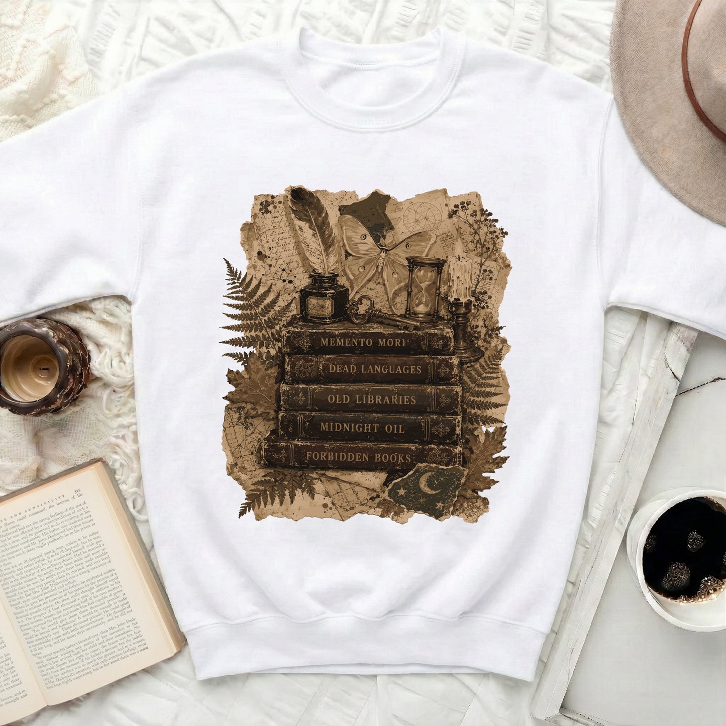 Sweatshirt with vintage illustration of books, moth, hourglass, and feather pen.