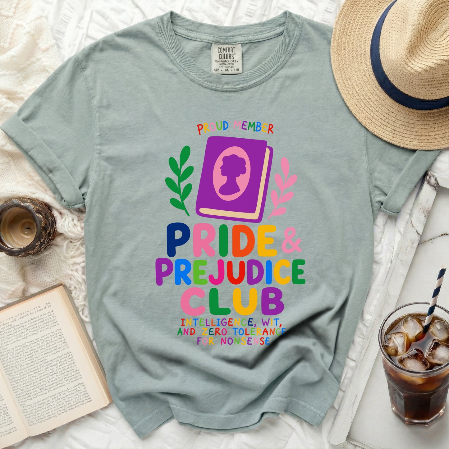 Green t-shirt with "Pride & Prejudice Club" and book graphic.