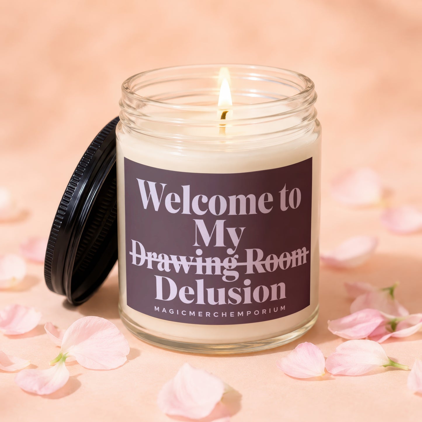 Lit jar candle with black lid, reads "Welcome to My Drawing Room Delusion".