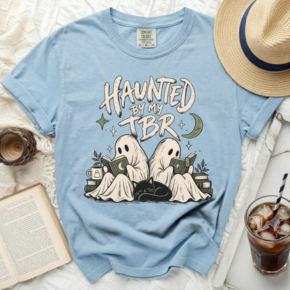 Light blue t-shirt with ghosts reading and "Haunted by my TBR" text.